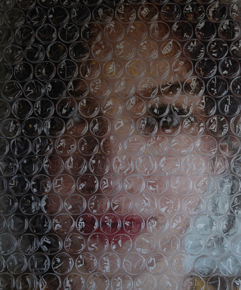 Image #2 of Sophia behind bubble wrap